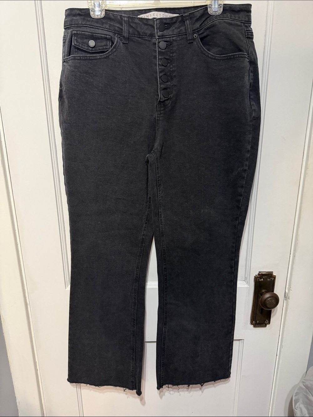High-Rise Button-Front Black Jeans — wide leg/raw hem